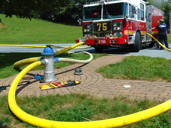 Supply hose connected to fire hydrant outlets.