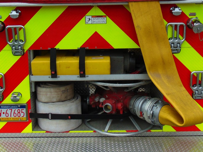 Large-diameter hose connected to a manifold used for rural firefighting.